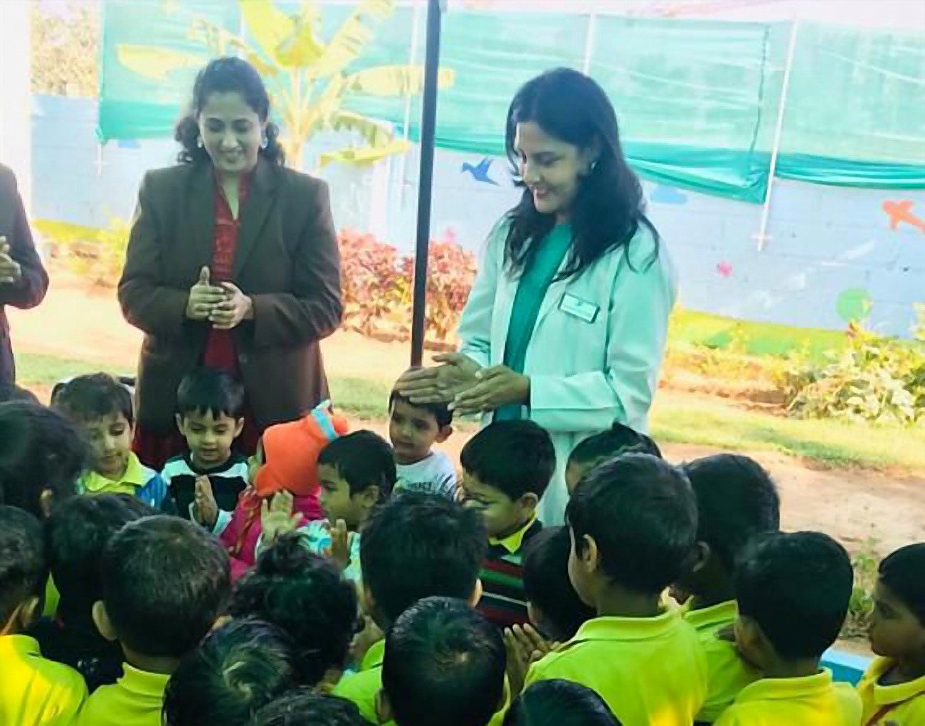Dr. Rinku Das addressing a large group of seated schoolchildren at the free eye camp