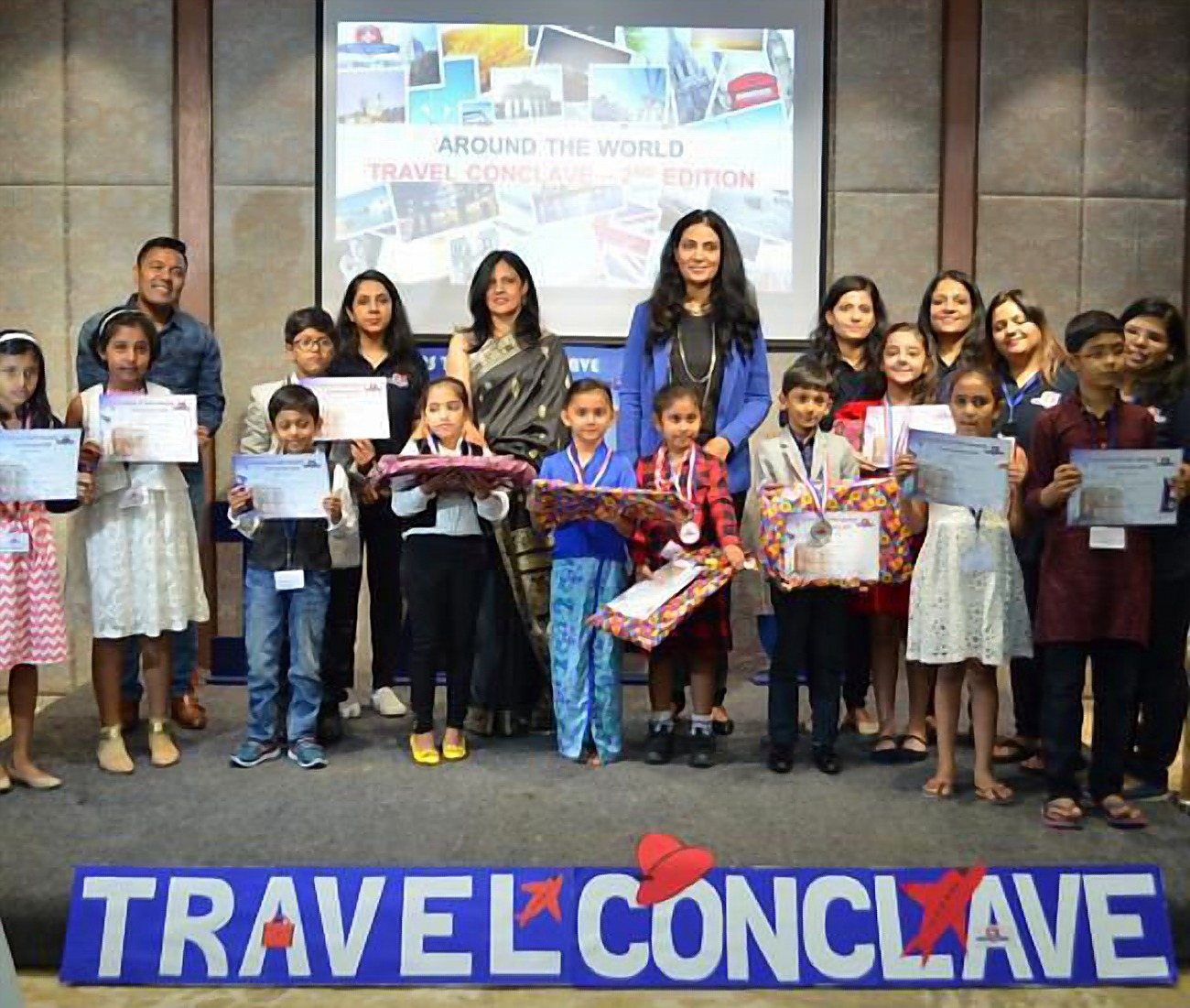 Children holding their certificates at the public speaking event
