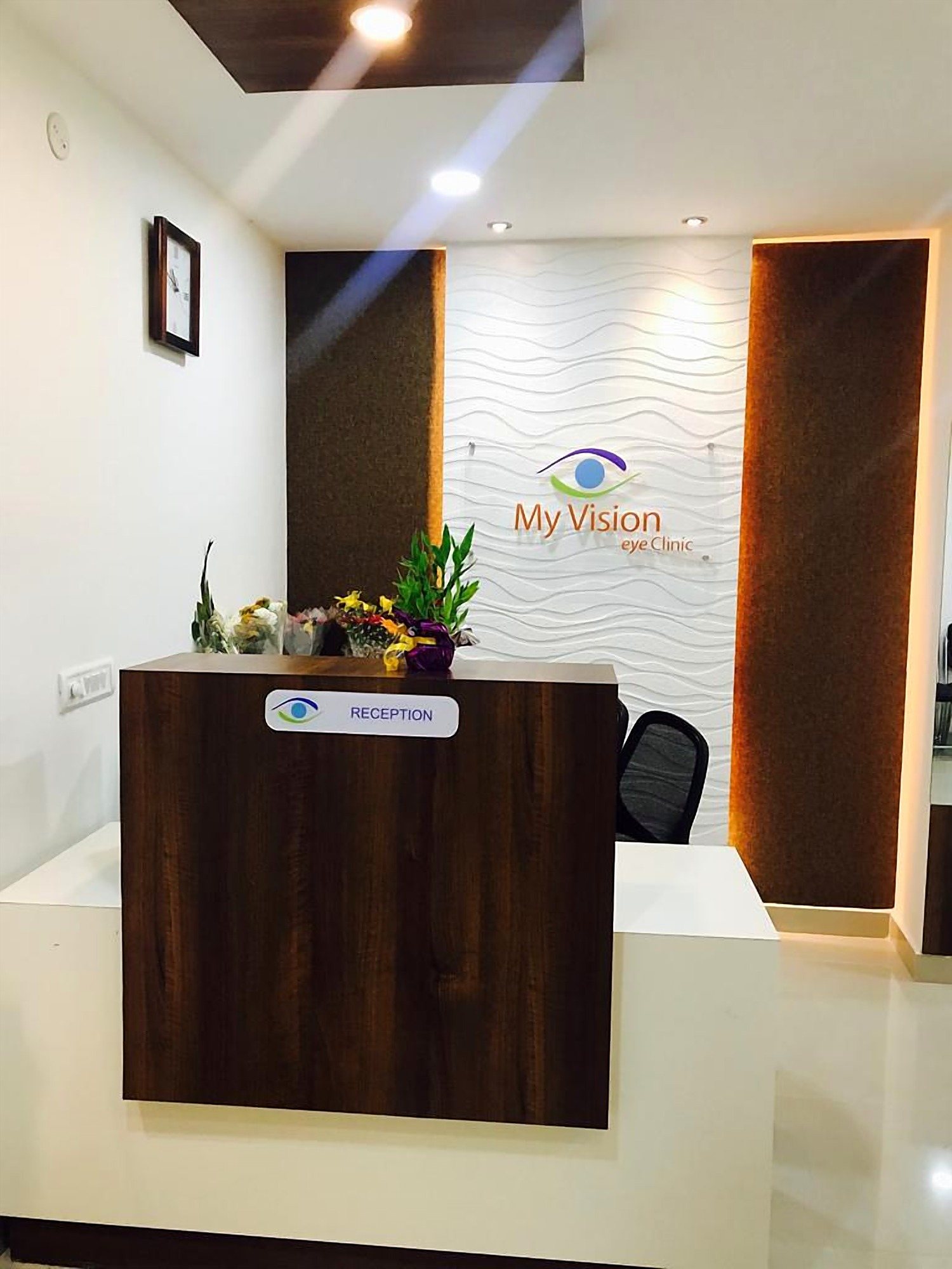 The reception desk, with the clinic logo behind it