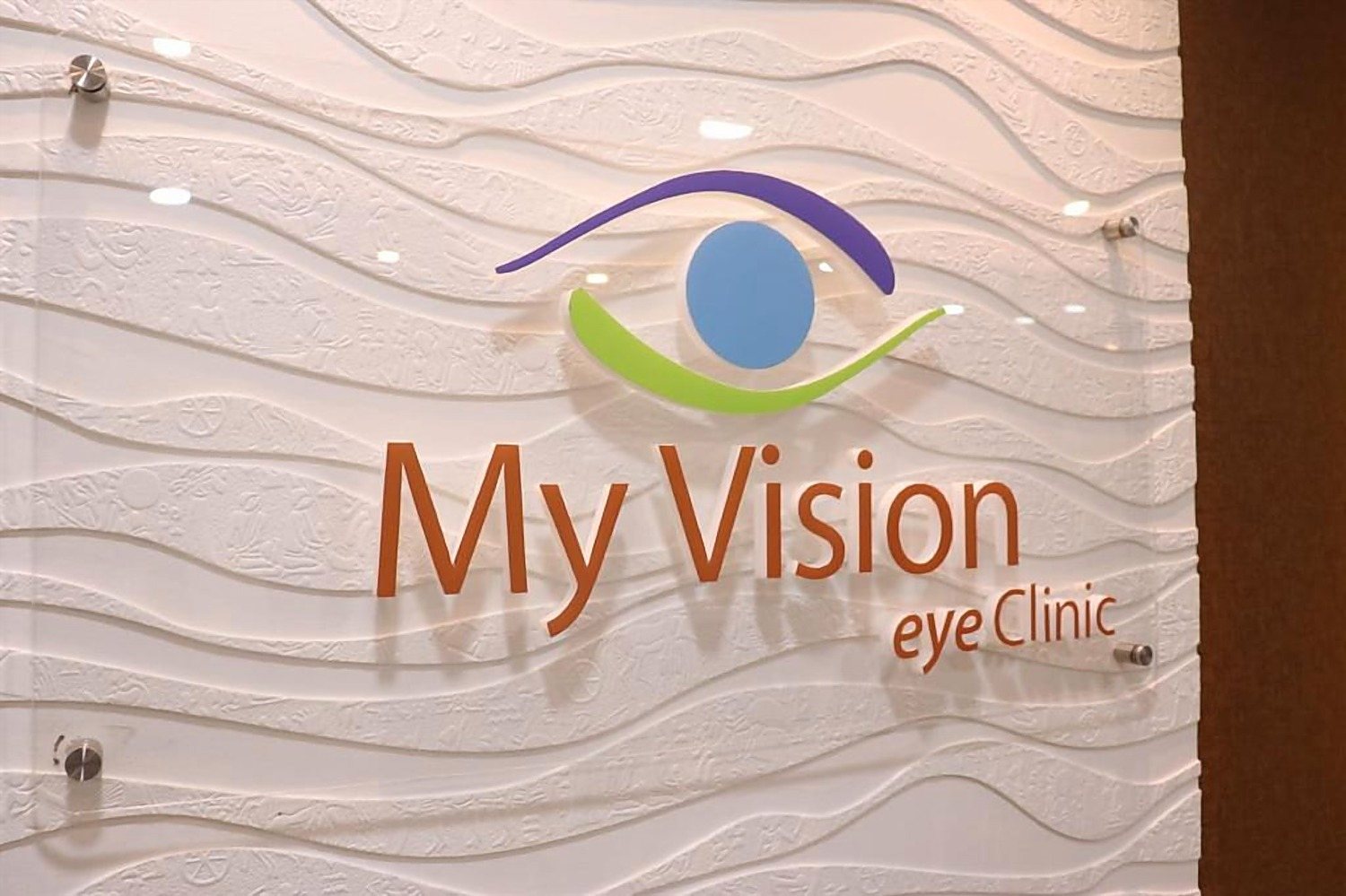 The clinic wall carrying the logo and the Protect, Care, Enhance line