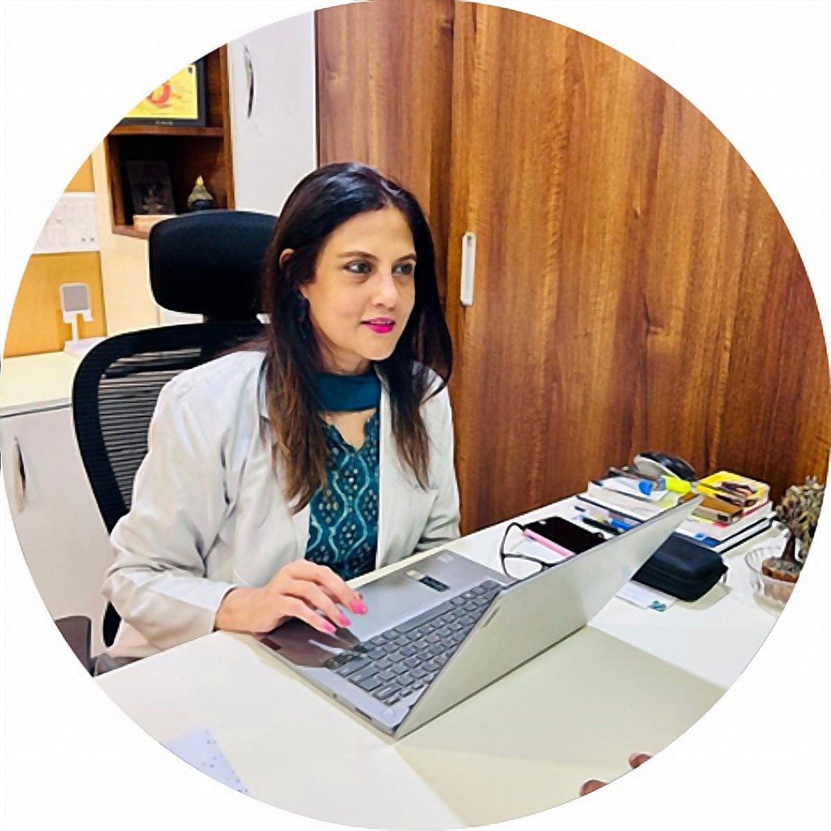 Dr. Rinku Das at her desk in the clinic