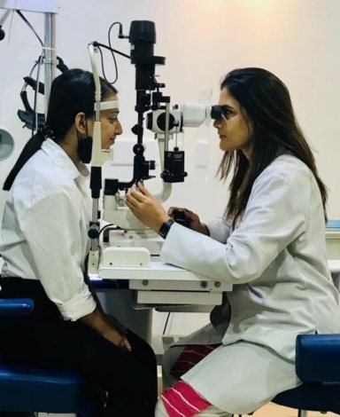 Dr. Rinku Das examining a patient at the slit lamp