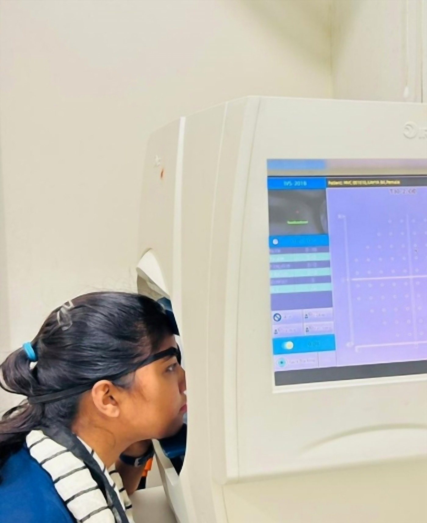 A member of the team running a computerised eye test