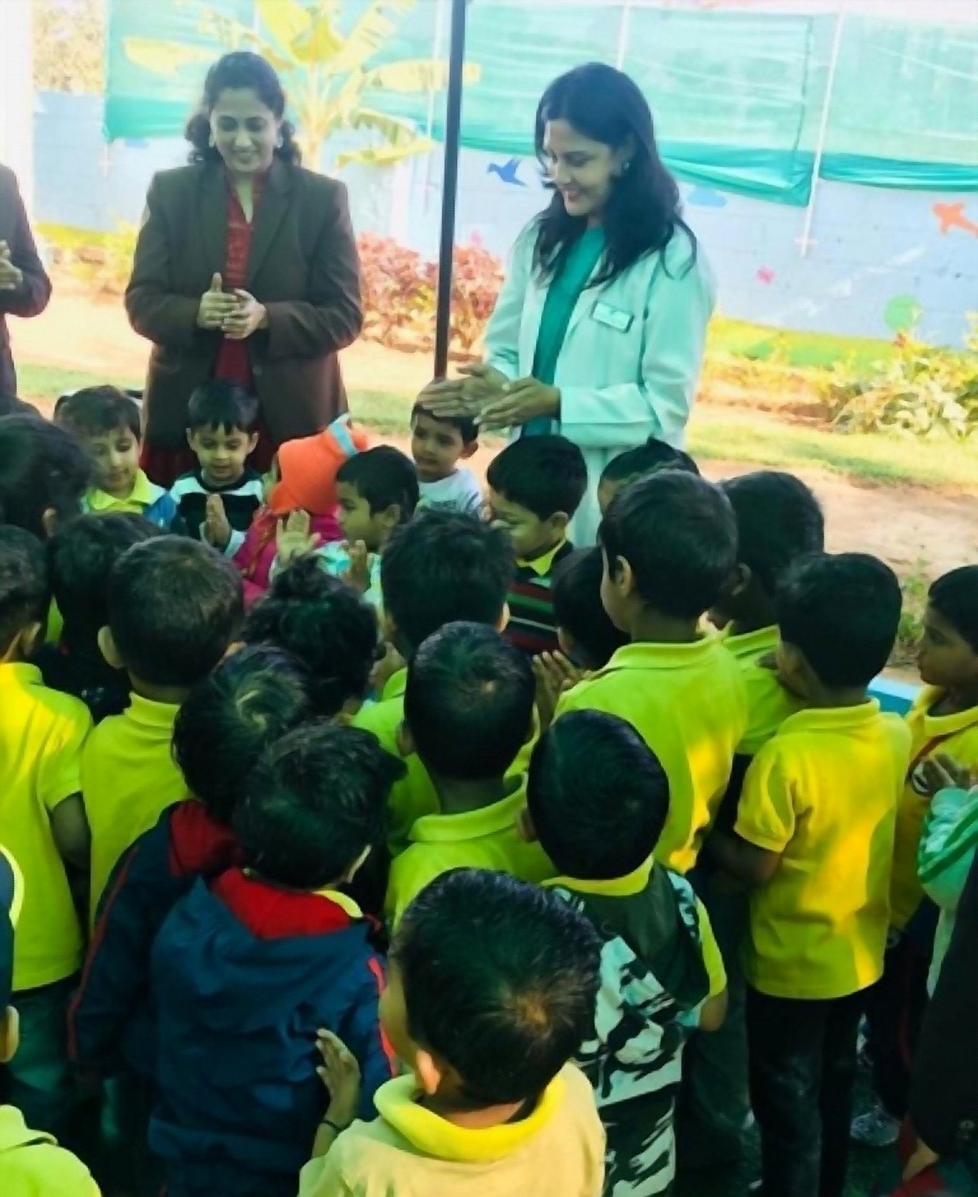 Dr. Rinku Das speaking to a large group of schoolchildren at a screening camp
